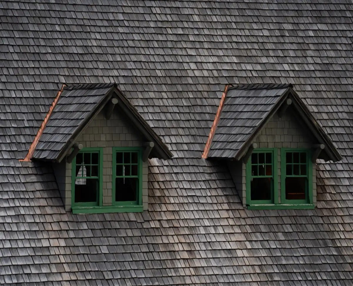 Dormers on a shingle roof in Edmond, OK, where step flashing and kickout flashing carry water past the walls